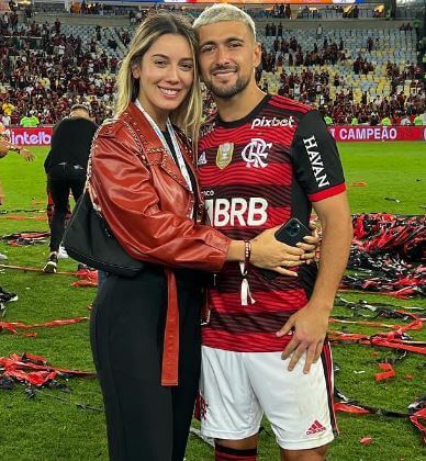 Reyna with her husband Giorgian de Arrascaeta in the field.